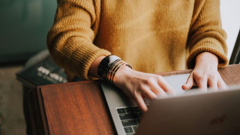 Close up shot of person using laptop